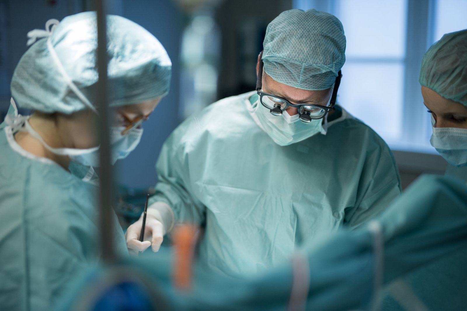Drei Personen während einer Operation